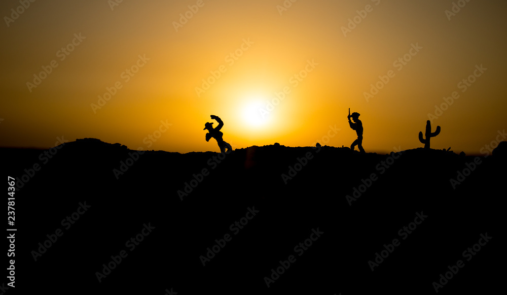 Cowboy concept. Silhouette of Cowboys at sunset time. Cowboys silhouettes on a hill with horses. Cowboy concept. Silhouette of Cowboys at sunset time. Cowboys silhouettes on a hill with horses.