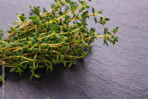essential oil of thyme on a dark stone background