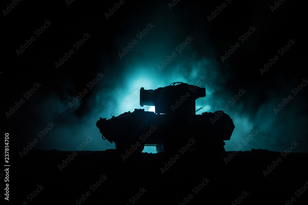 Obraz premium War Concept. Military silhouettes fighting scene on war fog sky background, World War German Tanks Silhouettes Below Cloudy Skyline At night. Attack scene. Armored vehicles. Tanks battle