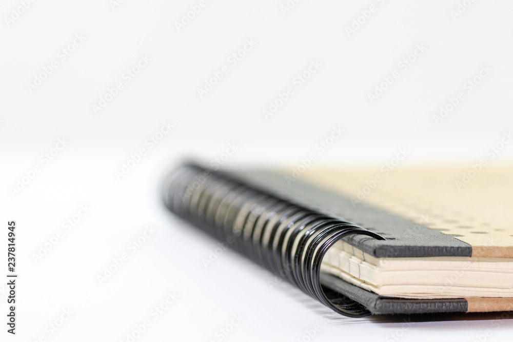 Focusing on the spiral binding of a notebook., white background Focusing on the spiral binding of a notebook., white background
