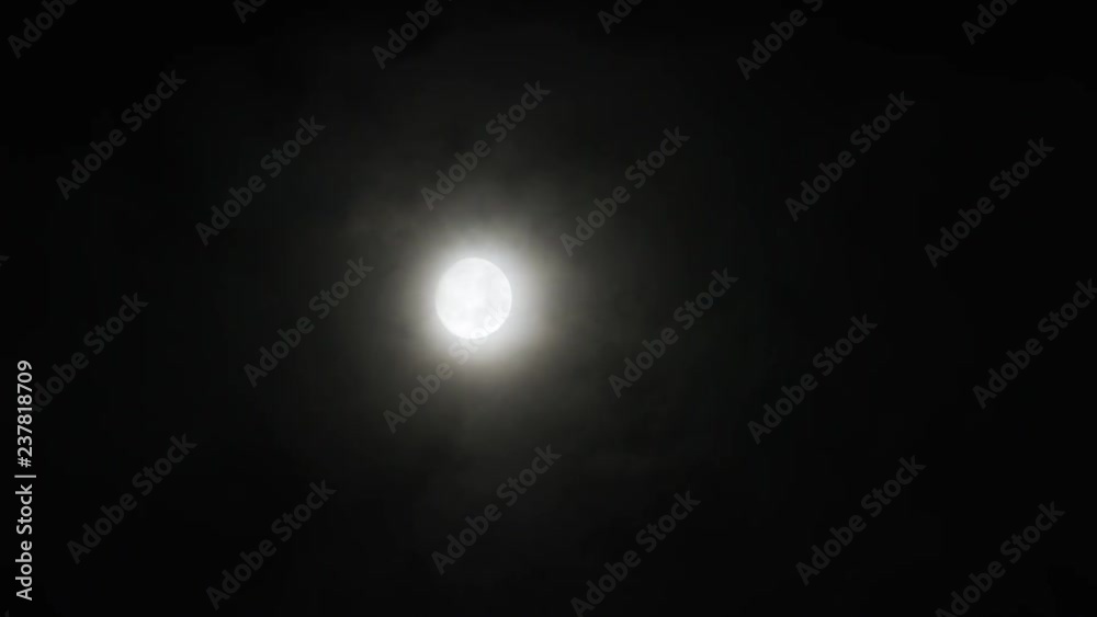 A realtime shot of the moon and clouds in the night sky. A realtime shot of the moon and clouds in the night sky.
