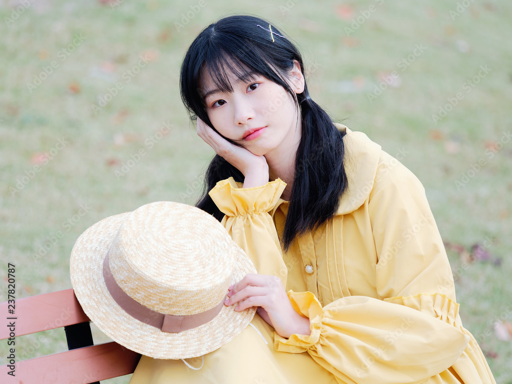 Outdoor portrait of beautiful young Chinese girl in yellow dress and ...
