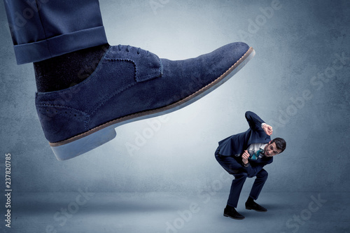Big foot trying to crush small man who is afraid of that
