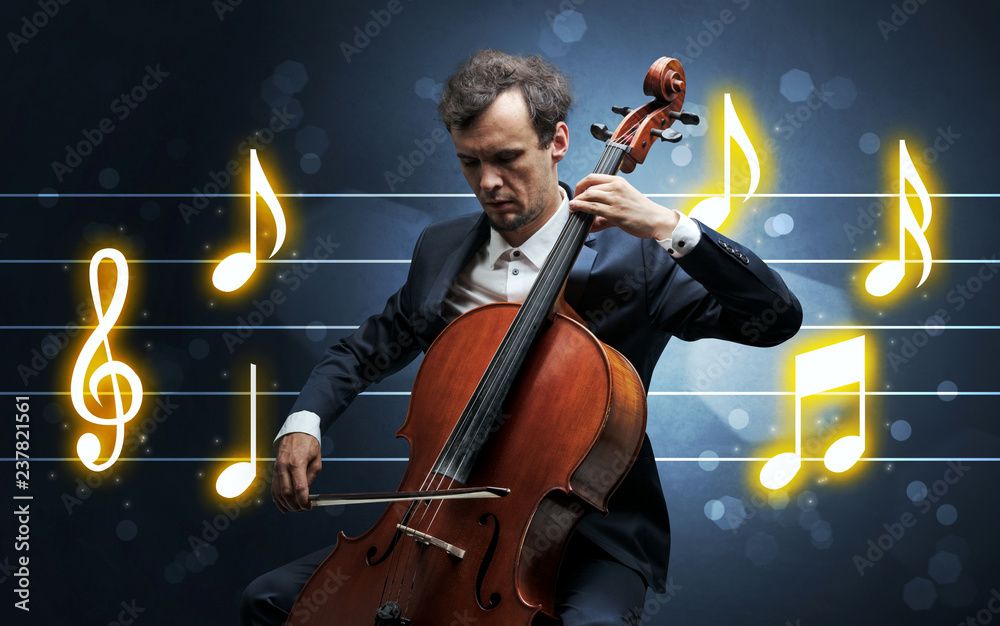 Fototapeta premium Young handsome cellist playing with music sheet background