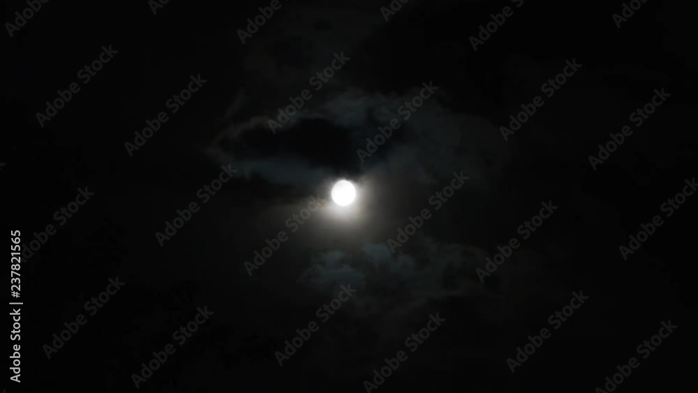 A realtime shot of the moon and clouds in the night sky. A realtime shot of the moon and clouds in the night sky.