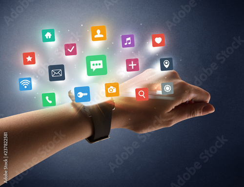 Naked female hand with smartwatch and application labels around and dark background