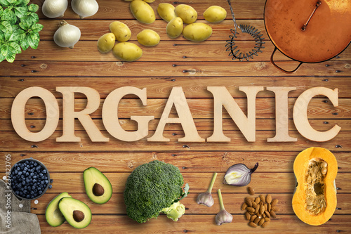 Word "Organic" in wooden letters with many cooking ingredients