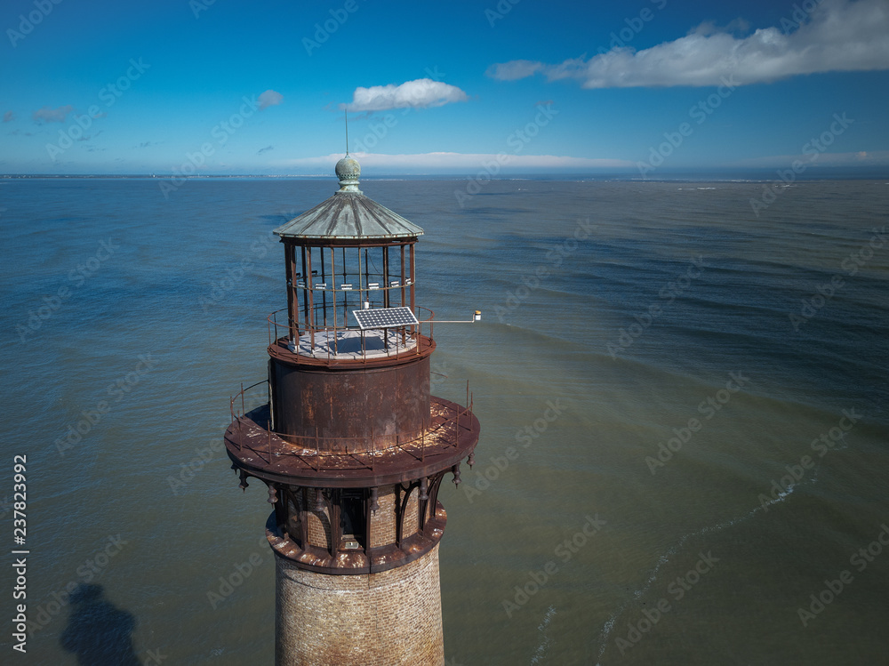 Aerial drone image of the historic Morris Island Lighthouse now inactive but destroyed during the Civil War and eroded by storms and global warming