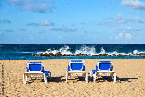 Pristine Caribbean beach with beach chairs   © yobab