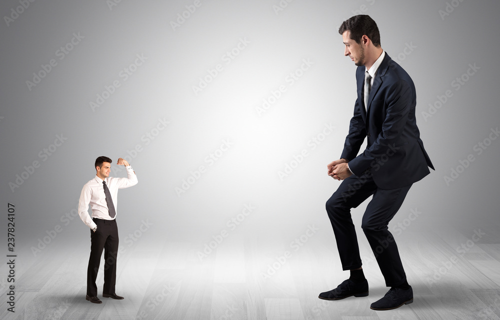 Big debutant young businessman scared of small strong businessman
Big debutant young businessman scared of small strong businessman