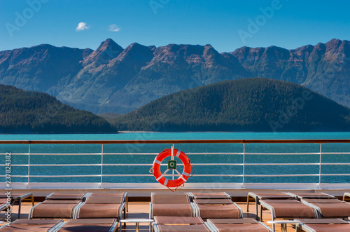 Empty cruise ship lounge chairs and life ring, Lido Deck. Alaska, USA.