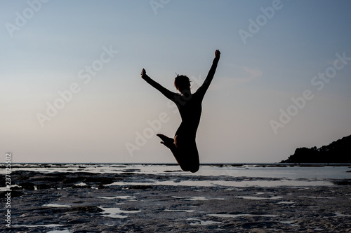 Yoga by woman in silhouette with sunset sky background. Free space for text 