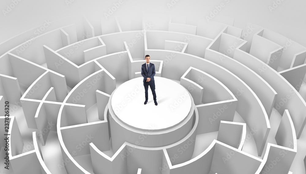 Businessman standing on the top a maze and looking through
Businessman standing on the top a maze and looking through