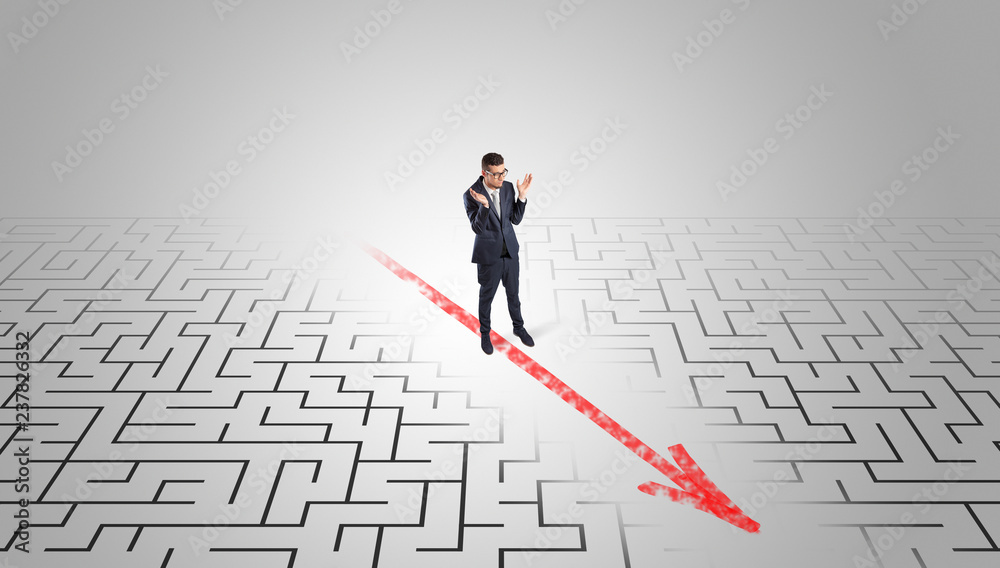 Businessman going through the maze with red arrow
Businessman going through the maze with red arrow