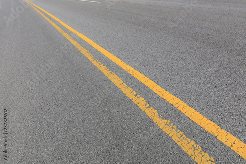 Yellow double solid line on the asphalt road © YuanGeng