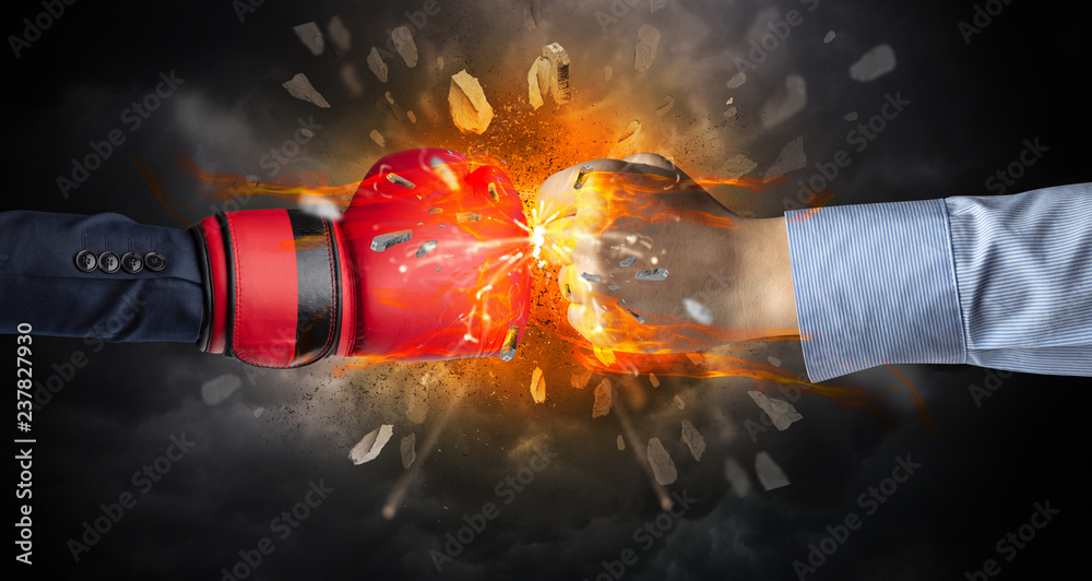 Naklejka premium Two hands fighting and breaking a rock into small pieces 