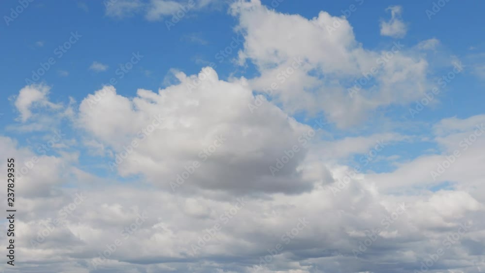 Blue sky background with white clouds. Long shot