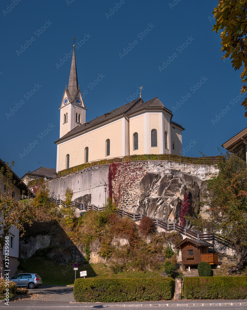 Kaprun, Austria. Catholic church St. Margaretha. Church on the mountain. Steep stairs lead to the church