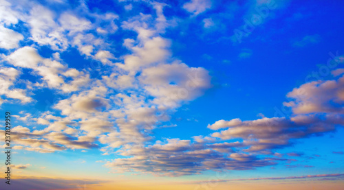 Beautiful contrast clouds and blue sky with yellow gradient before sunset background. Nature weather, cloud blue sky and sun