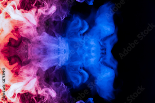 A dynamic explosion of puffs of smoke of light blue pink and red colors on a black background with smooth fire rendering an isolated pattern in the form of a medusa.