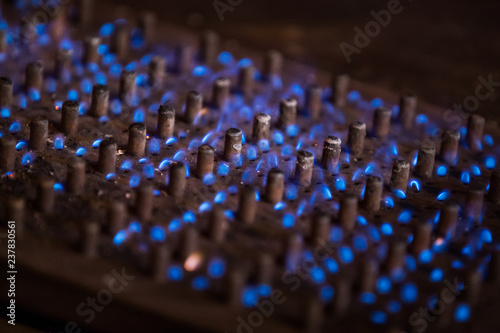 a large burner at a wedding getting warm with beautiful blue flames, clicked with a tele lens at a selective focus