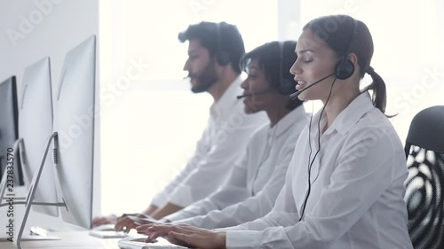 Call Center Agents Consulting Clients On Hotline At Office