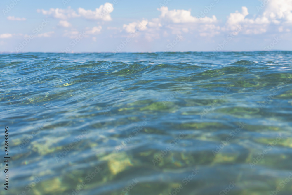 Background of the smooth and soft natural transparent sea water with bokeh.