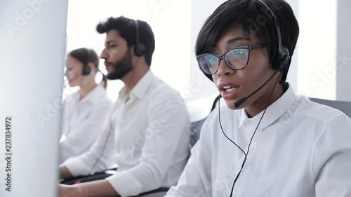 People Work At Contact Center. Woman In Headset Working