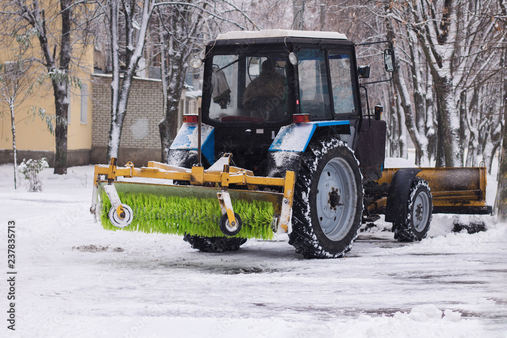Tractor removes snow after blizzards in the streets