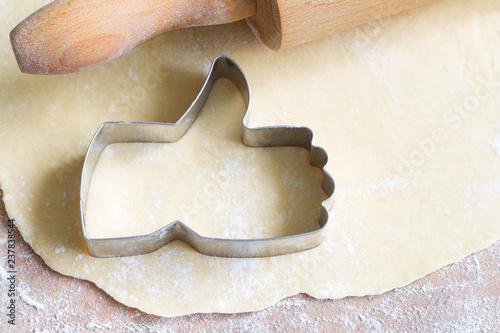 I like baking food concept with thumbs up cookie cutter on wooden background
 photo