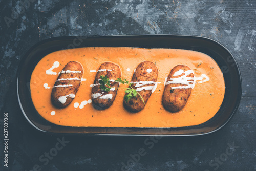 Malai Kofta Curry is a Mughlai special recipe served in a bowl. Selective focus photo