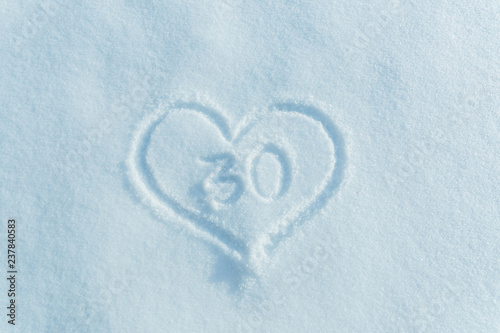 A figure of thirty written in the snow in the painted heart. 