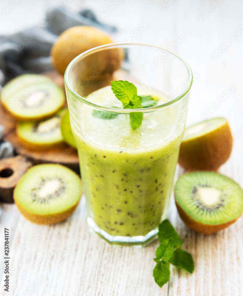 Glass of kiwi smoothie with fresh fruits