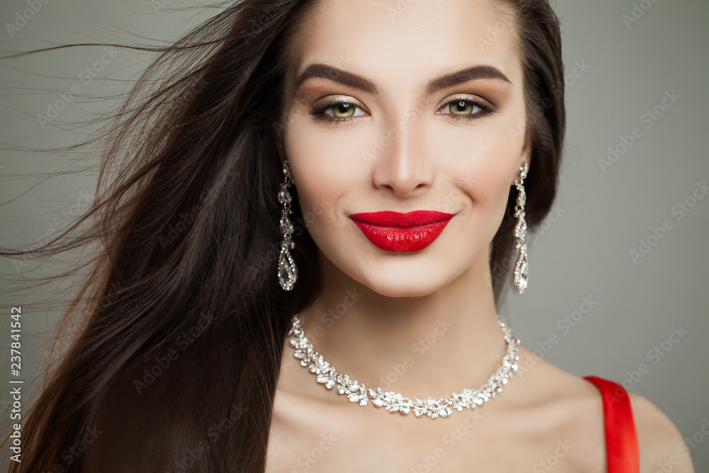 Perfect female face closeup. Glamorous brunette woman with blowing hair and red lips makeup Perfect female face closeup. Glamorous brunette woman with blowing hair and red lips makeup