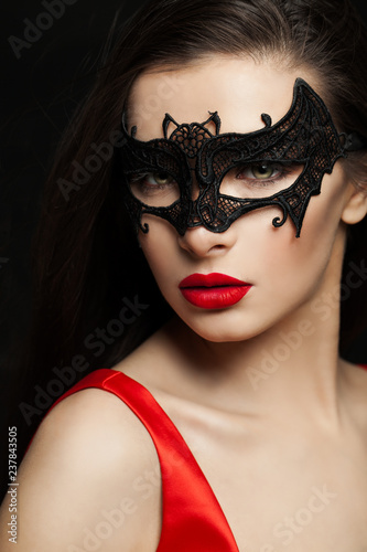 Sexy brunette woman in carnival mask, female face closeup