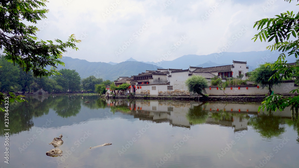 The water Reflection of Hongcun village in morning. Hongcun Village, Anhui China : one of most attractive ancient village in China. The water Reflection of Hongcun village in morning. Hongcun Village, Anhui China : one of most attractive ancient village in China.