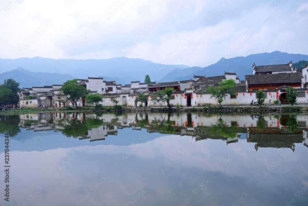 Fototapeta premium The water Reflection of Hongcun village in morning. Hongcun Village, Anhui China : one of most attractive ancient village in China.