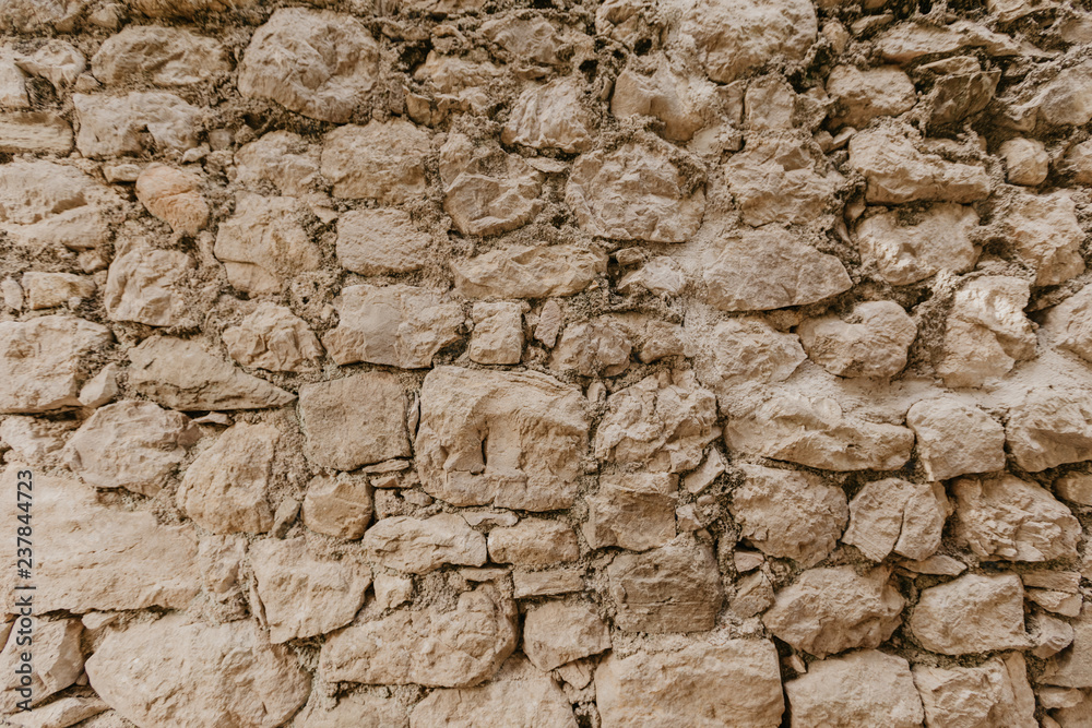 Texture of a stone wall. Old castle stone wall texture background. Stone wall as a background or texture. Part of a stone wall
