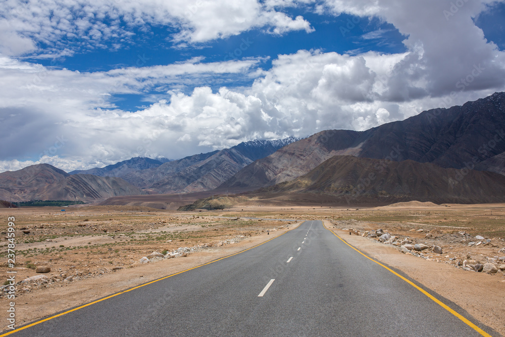 Empty road through HImalayas mountains in Ladakh, Northern India. Road trip concept