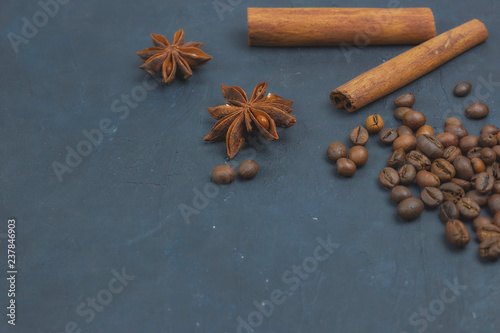 roasted coffee beans scattering in the corner of the background. beans on a dark background. view from above. copy space.