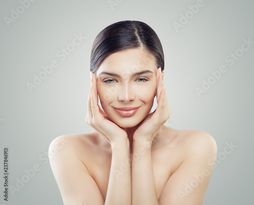 Cheerful woman spa model. Facelift, skincare and facial treatment concept