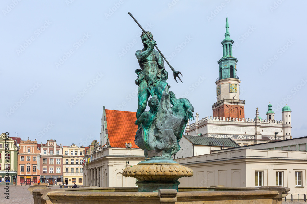 Neptune fountain with the city hall tower in the background on the Main Market (Rynek) square in the Old Town of Poznan, Poland
