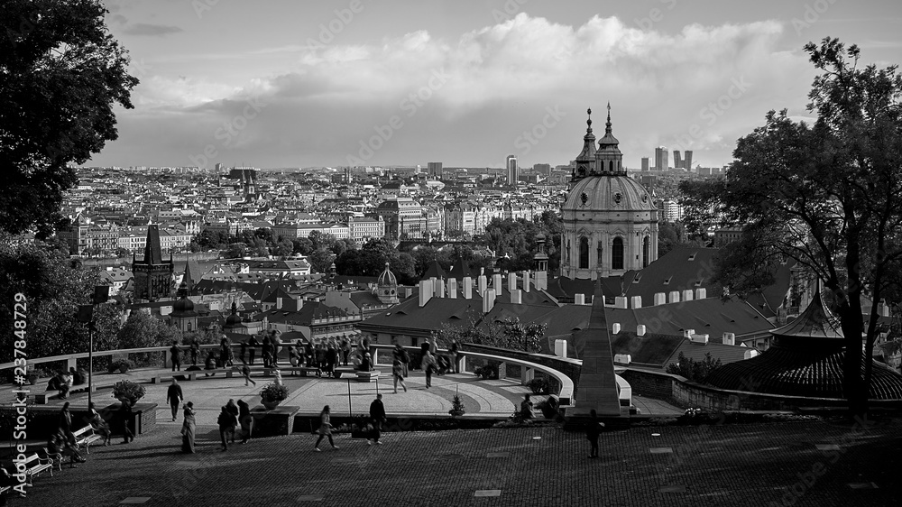 Aerial view of Prague from Prague Castle. Prague, Czech Republic. Tourists people looking over the beautiful city and relaxing. Black and white