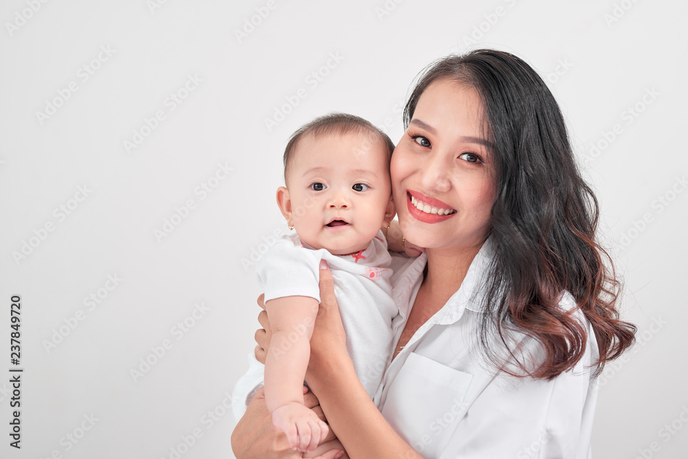 Motherhood and lifestyle concept. Smiling young mother with little baby at home Motherhood and lifestyle concept. Smiling young mother with little baby at home