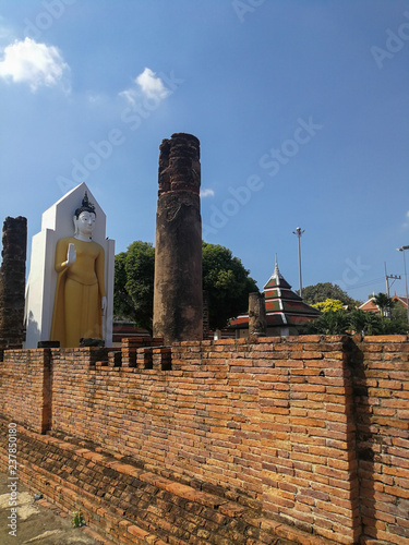 Standing Buddha Statue, Ancient buddhist Thai temple in Wat Pra sri rattana mahathat woramahavihan (Wat Yai) Phitsanulok, Thailand.