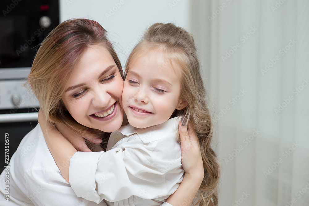 Happy Mother and daughter are hugging at home