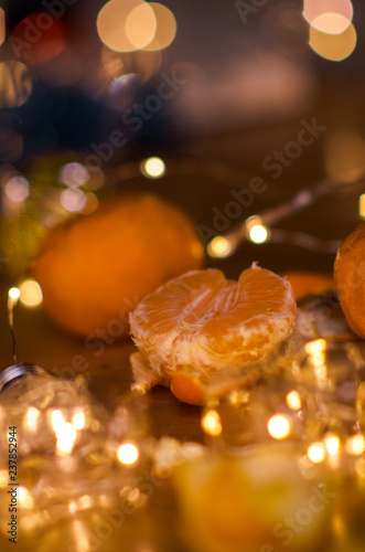 Tangerines and beautiful lights and bokeh in the background .New year. Christmas card