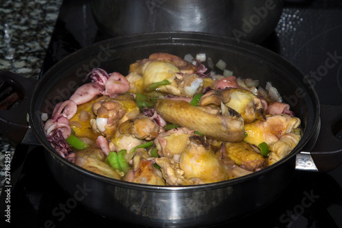 stew of meat, chicken with peas and squid