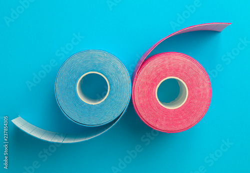 Obraz na plátně Pink and blue kinesiotape on blue background