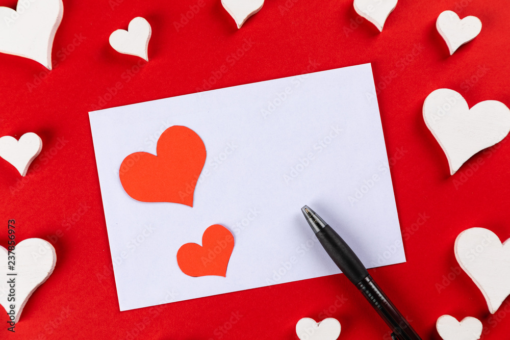 top view with red background with hearts for writing a love letter for ...